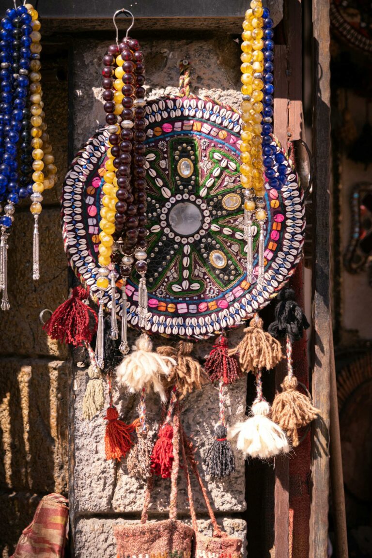 Vibrant arrangement of traditional beads and tassels hanging in a store display.